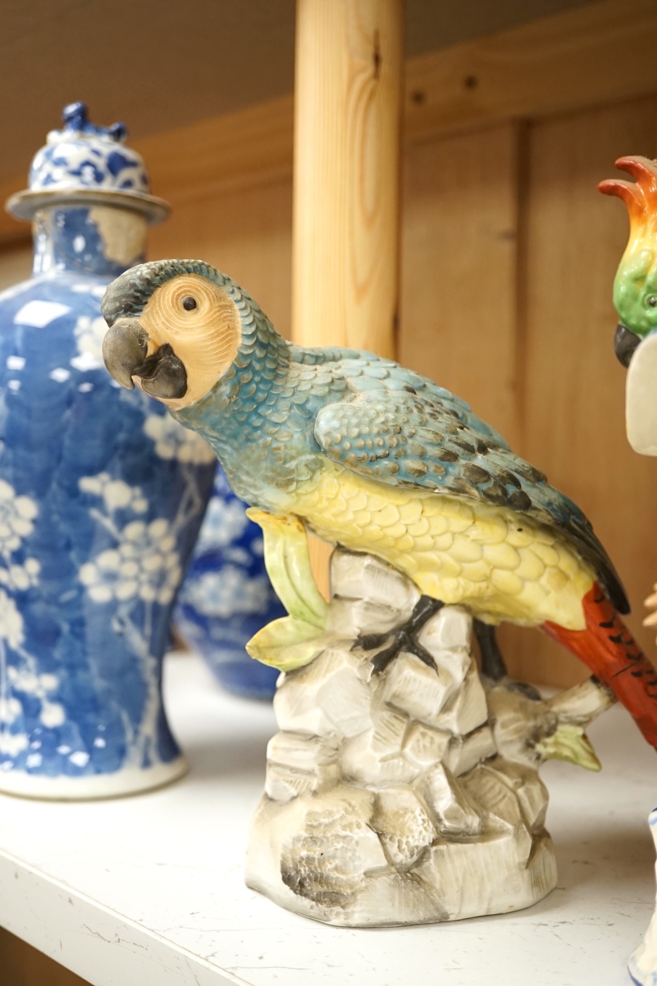 A group of twelve ceramic parrots including one by S Hancock & Sons, largest 24cm high. Condition - mostly good